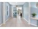 Living room showcasing tile flooring, columns, and sliding doors leading to the patio at 3203 Audubon Ct, Tarpon Springs, FL 34688