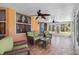 Relaxing sunroom featuring wicker furniture, tile floor, and view of trees at 3203 Audubon Ct, Tarpon Springs, FL 34688