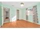 Light and airy bedroom with wood floors and access to hallway at 3826 Highgate Dr, Valrico, FL 33594