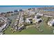 An aerial view of a waterfront community with a condo building and boat docks at 401 150Th Ave # 262, Madeira Beach, FL 33708