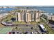 Aerial view of building, parking, tennis court, and water access at 401 150Th Ave # 262, Madeira Beach, FL 33708