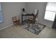 Neutral bedroom with a desk, chair, mirror, and floral rug creating a cozy and functional space at 6741 Willits Ave, New Port Richey, FL 34655