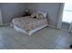 Bedroom with a bed and tile flooring at 6741 Willits Ave, New Port Richey, FL 34655