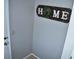 Home entryway with a decorative 'HOME' sign and neutral paint, creating a welcoming space at 6741 Willits Ave, New Port Richey, FL 34655