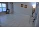 Well-lit living room featuring neutral paint, tile flooring, and large bright window at 6741 Willits Ave, New Port Richey, FL 34655