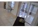 Bright living room featuring tile floors, sliding glass doors, and neutral decor at 6741 Willits Ave, New Port Richey, FL 34655