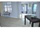 Bright living room featuring tile floors, sliding glass doors, and neutral decor at 6741 Willits Ave, New Port Richey, FL 34655