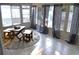 Bright sunroom with tile flooring, large windows, and wooden furniture, creating a cozy retreat at 6741 Willits Ave, New Port Richey, FL 34655