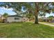 House exterior showcasing stone facade and mature tree at 8253 137Th Ln, Seminole, FL 33776