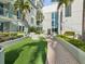 Brick pathway meanders through a landscaped courtyard with tropical plants at 912 Channelside Dr # 2601, Tampa, FL 33602