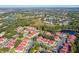 Aerial view of a community with red-roofed houses and a lake at 9481 Highland Oak Dr # 807, Tampa, FL 33647