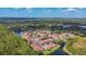 Aerial view of a community with red-roofed houses, lush greenery, and a lake at 9481 Highland Oak Dr # 807, Tampa, FL 33647