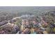 Aerial view of a large condo community nestled in woods near a lake at 9481 Highland Oak Dr # 807, Tampa, FL 33647
