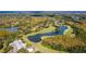 Aerial view of a golf course community with houses and lakes at 9481 Highland Oak Dr # 807, Tampa, FL 33647