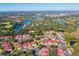 Aerial view of a community with red-roofed houses and a central pool area at 9481 Highland Oak Dr # 807, Tampa, FL 33647