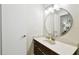 Bathroom with a vanity and large round mirror at 9481 Highland Oak Dr # 807, Tampa, FL 33647