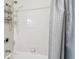 Simple bathroom with shower, tub and gray shower curtain at 9481 Highland Oak Dr # 807, Tampa, FL 33647