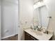Modern bathroom with updated vanity and large mirror at 9481 Highland Oak Dr # 807, Tampa, FL 33647