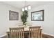 Bright dining room with light wood table, chairs, and decorative wall art at 9481 Highland Oak Dr # 807, Tampa, FL 33647