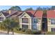 Two-story condo building with red roof, balcony, and landscaping at 9481 Highland Oak Dr # 807, Tampa, FL 33647