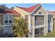 Tan condo building with red tile roof and screened balcony at 9481 Highland Oak Dr # 807, Tampa, FL 33647