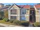 Tan two-story condo building with red roof, balcony, and landscaping at 9481 Highland Oak Dr # 807, Tampa, FL 33647
