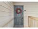 Gray front door with wreath and keyless entry at 9481 Highland Oak Dr # 807, Tampa, FL 33647