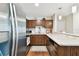 Modern kitchen with stainless steel appliances and wood cabinets at 9481 Highland Oak Dr # 807, Tampa, FL 33647