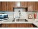 Kitchen sink and countertops with wood cabinets at 9481 Highland Oak Dr # 807, Tampa, FL 33647