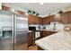 Modern kitchen with stainless steel appliances and wood cabinets at 9481 Highland Oak Dr # 807, Tampa, FL 33647