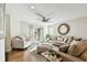 Bright living room with hardwood floors, neutral colored furniture and ceiling fan at 9481 Highland Oak Dr # 807, Tampa, FL 33647