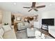 Comfortable living room with hardwood floors, neutral furniture, and view of kitchen at 9481 Highland Oak Dr # 807, Tampa, FL 33647