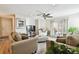 Spacious living room with hardwood floors, neutral furniture and access to balcony at 9481 Highland Oak Dr # 807, Tampa, FL 33647