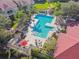 Community pool with patio furniture and grilling area at 9481 Highland Oak Dr # 807, Tampa, FL 33647
