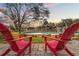 Relaxing backyard oasis with red chairs and above ground pool at 1307 Windjammer Pl, Valrico, FL 33594