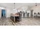 Open concept dining room with kitchen views and wood-look floors at 1307 Windjammer Pl, Valrico, FL 33594