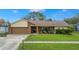 House exterior with a two-car garage and well-maintained lawn at 1307 Windjammer Pl, Valrico, FL 33594