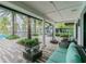 Covered patio with comfortable seating overlooking pool at 2409 Hearth Dr, Odessa, FL 33556