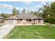 Aerial view of a tan house with a large grassy yard and solar panels at 2609 65Th E St, Bradenton, FL 34208