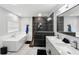Elegant bathroom with double vanity, soaking tub, and walk-in shower at 2609 65Th E St, Bradenton, FL 34208