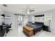 Bedroom with barn door, workspace, and ceiling fan at 2609 65Th E St, Bradenton, FL 34208