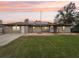 Tan house with solar panels, stone patio, and grassy yard at 2609 65Th E St, Bradenton, FL 34208