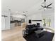 Open concept living room with kitchen, island, and fireplace at 2609 65Th E St, Bradenton, FL 34208