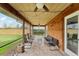 Spacious screened porch with wood-paneled walls and ceiling fan at 2609 65Th E St, Bradenton, FL 34208