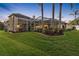 Expansive backyard oasis with a screened enclosure and lush greenery at 2914 Shipston Ave, New Port Richey, FL 34655