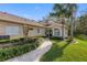 House with a walkway, lush landscaping, and palm trees at 2914 Shipston Ave, New Port Richey, FL 34655