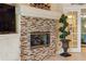 Elegant fireplace with a mosaic tile surround and built-in shelving at 2914 Shipston Ave, New Port Richey, FL 34655