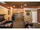 Home theater bar with wood cabinets, granite countertop, and mini-fridge at 2914 Shipston Ave, New Port Richey, FL 34655