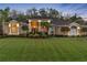 Luxury home exterior at dusk with a beautifully landscaped yard at 2914 Shipston Ave, New Port Richey, FL 34655
