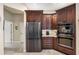 Kitchen features stainless steel appliances and rich wood cabinets at 2914 Shipston Ave, New Port Richey, FL 34655